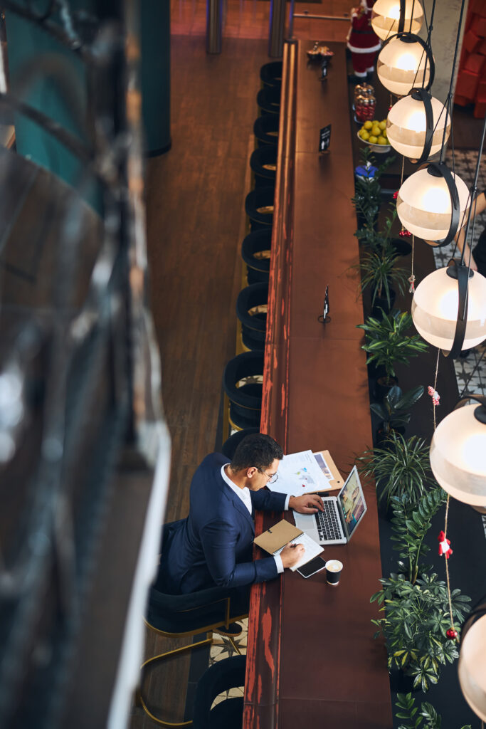 young man working alone at cafe