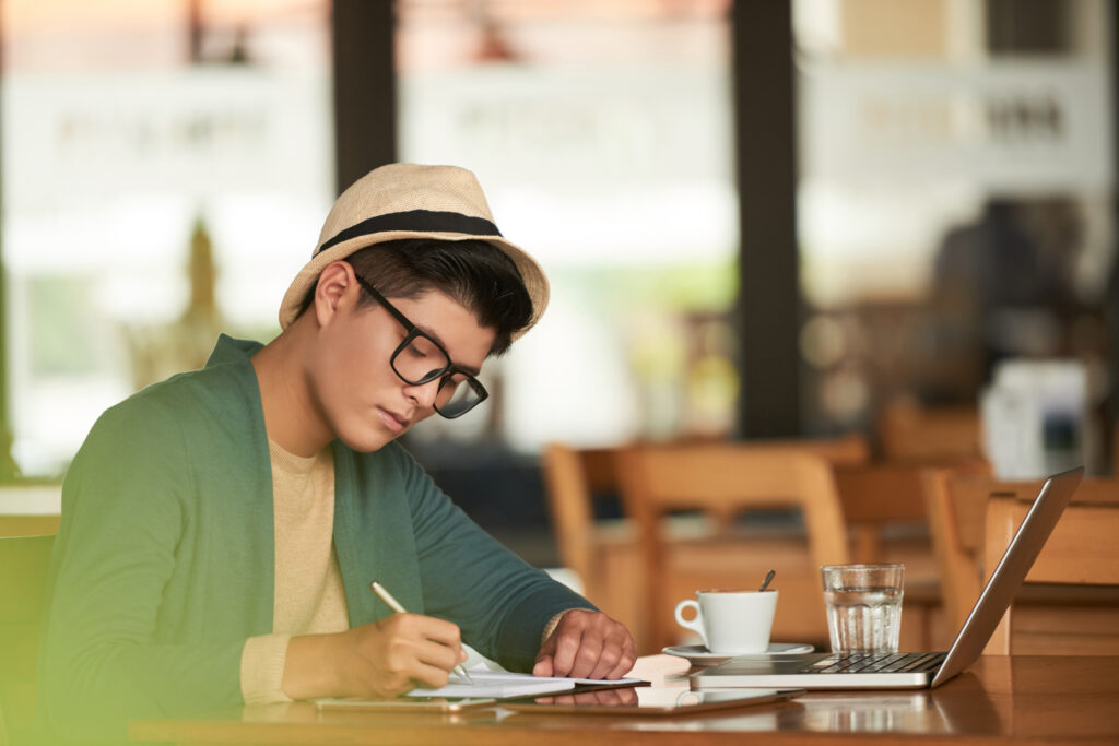 young man working using tab in a cafe